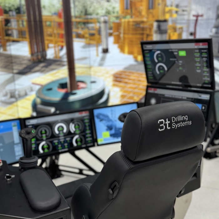 Picture from behind showing chair, controls and screens for drilling and well control simulator training
