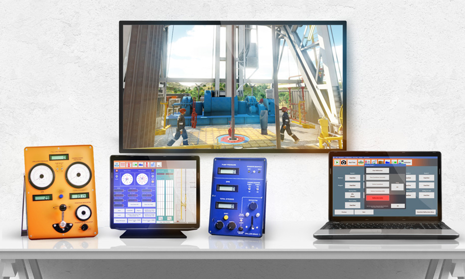 A desk displays a monitor showing an industrial scene, alongside an orange device, a tablet with a blue screen, a blue device with knobs, and a laptop with a grid interface.